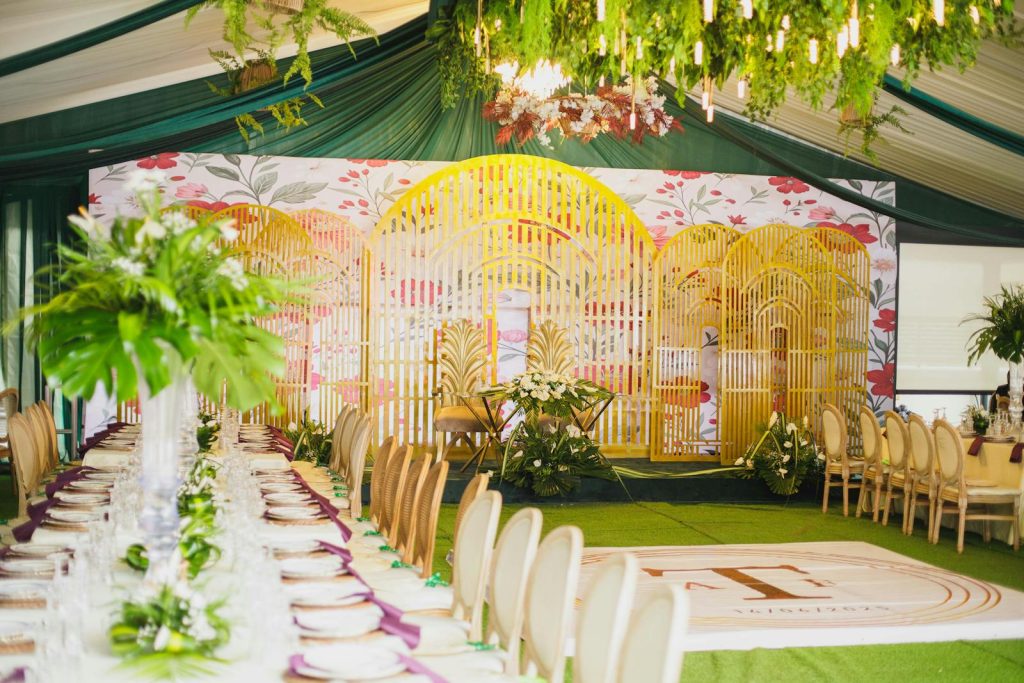 Luxurious indoor wedding reception with decorative floral design and elegant dining setup.