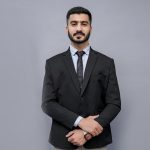 a man in a suit and tie posing for a picture