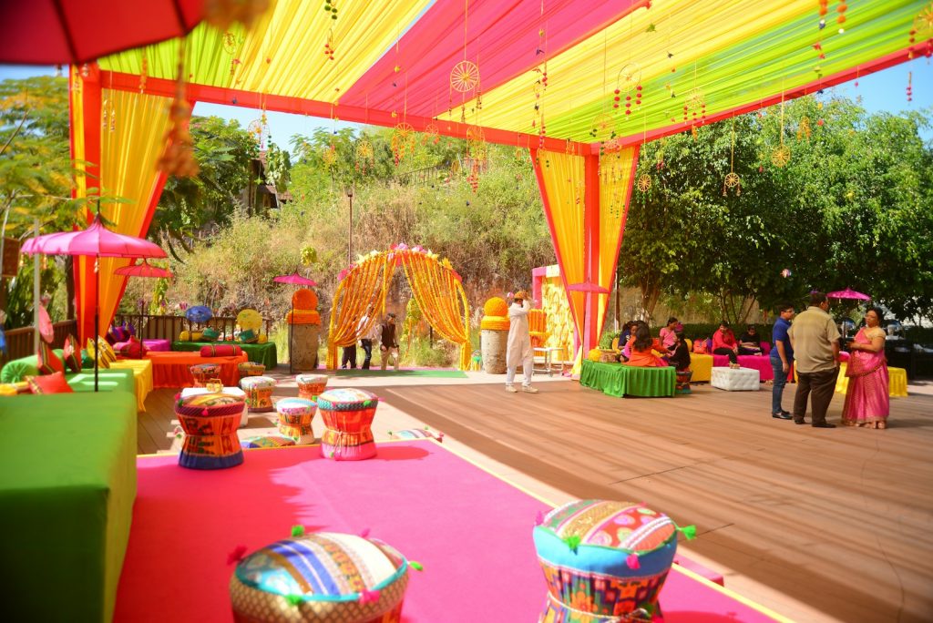 A vibrant outdoor event decorated in colorful tents.