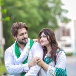 man in white dress shirt hugging woman in blue and white floral dress