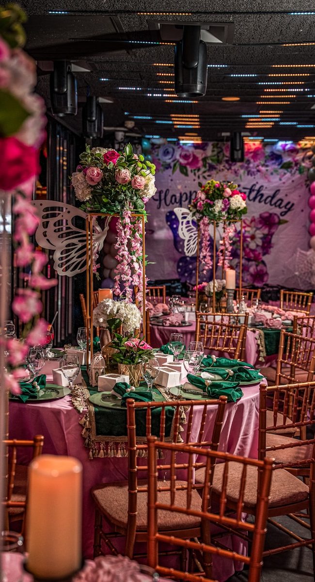 Elegant birthday party setup with floral decorations and balloons.